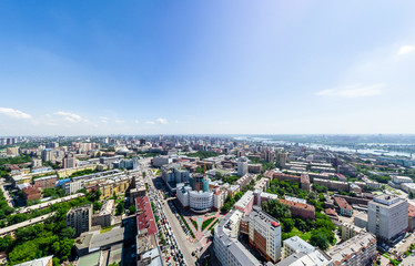 Aerial city view with crossroads and roads, houses, buildings, parks and parking lots, bridges. Urban landscape. Copter shot. Panoramic image.