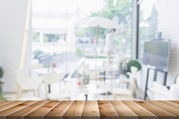 Empty brown wooden table and restaurant interior with some peopl