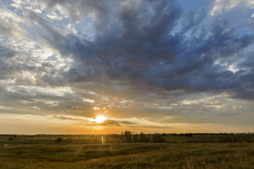 Fototapeta na wymiar meadow sunset clouds.