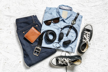 Overhead view of men's casual outfits on white wooden board, Ess