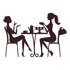 Two beautiful women sitting in a cafe