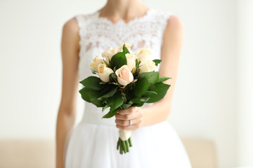 Bride in beautiful dress holding wedding bouquet