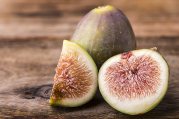 sliced of a fig isolated on wooden background