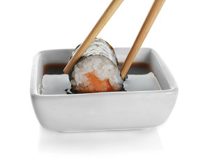 Delicious sushi roll with soy sauce, isolated on white