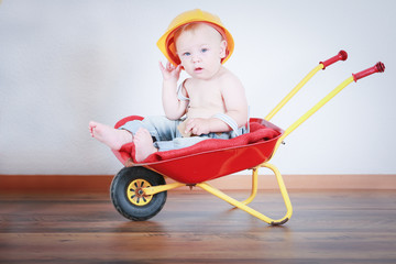 
six month old baby to play in the wheelbarrow
