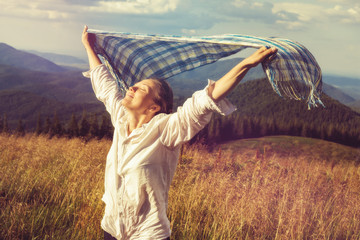 Young woman with fluttering scarf