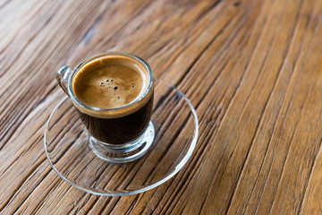 espresso shot in glass cup on wooden table