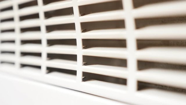 Domestic device room heating grille close-up shallow DOF slow tilt 4K 3840X2160 UltraHD video - Electric convector home heat radiator exchanger grill 4K 2160p 30fps UHD tilting footage 