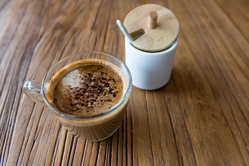 a cup of mocha with brown sugar jar