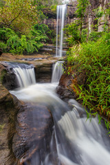 Soi Sawan Waterfall, The beautiful waterfall in deep forest during raining season at Pha Taem National Park, Ubon Ratchathani province, Thailand.