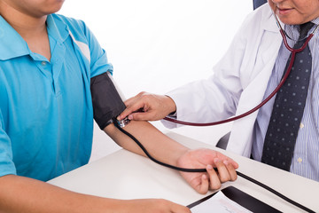 Asian medical doctor measuring blood pressure from patient arm
