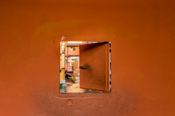 water canal hidden behind a window in Italy