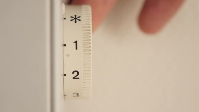 Regulating temperature on electirc home convector level adjust on dial 4K 2160p 30fps UltraHD footage - Adjusting thermostat level on home heating electric radiator 4K 3840X2160 UHD video 