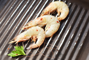 Marinated shrimps on the grill  with  red pepper and herbs