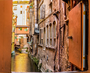 water canal hidden behind a window in Italy