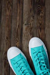 sneakers on empty wooden surface