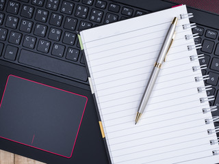 Blank notebook on laptop keyboard 11
