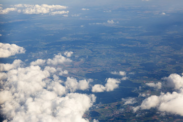 Fluffy clouds over the earth, the landscape. The scenic sky during sunset, the view from the air.