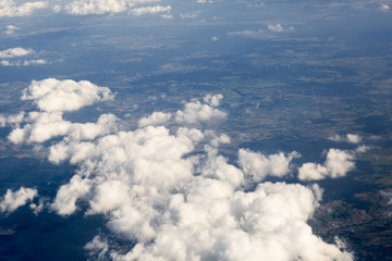 Fluffy clouds over the earth, the landscape. The scenic sky during sunset, the view from the air. © nadezhdaabramian