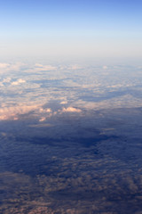 Fototapeta na wymiar Fluffy clouds over the earth, the landscape. The scenic sky during sunset, the view from the air.