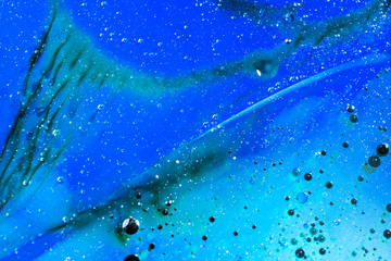 Abstract, colorful composition with oil, water and ink 
