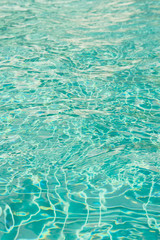 The sunlight on the surface of the water in the pool dimensional waves on water.