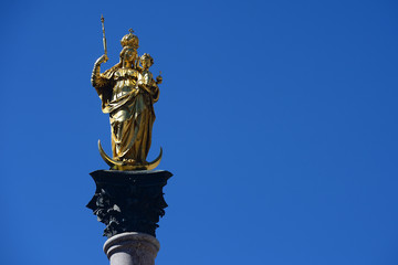 Fototapeta na wymiar The Golden statue of Mary (Mariensaule), a Marian column on the