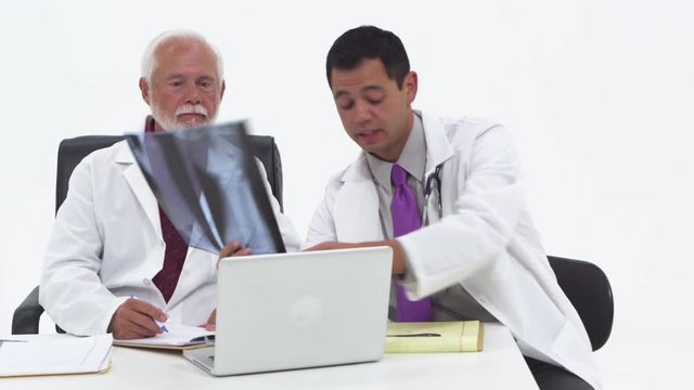 Two doctors discussing x-rays and notes