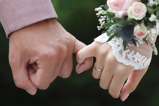 Closeup view of hands of a newlywed couple