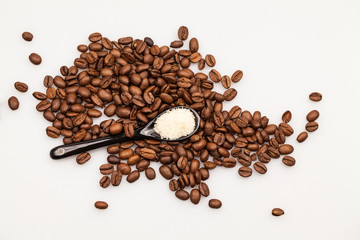 Coffee beans and small teaspoon with sugar