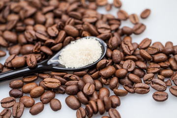 Coffee beans and small teaspoon with sugar