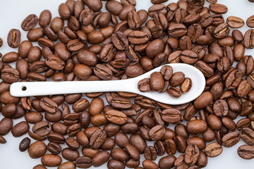 Coffee beans and small teaspoon with sugar
