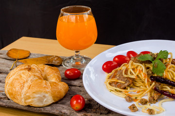 Italian pasta in tomato sauce, decorated with tomatoes and bread