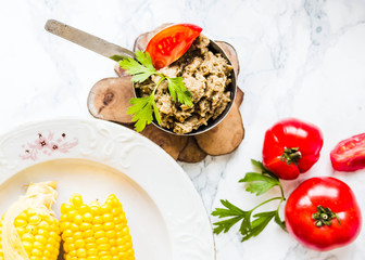 boiled sweet corn and tomatoes with salt and black, top view