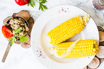 boiled sweet corn and tomatoes with salt and black, top view