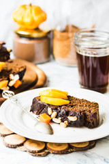 piece of chocolate cake with pumpkin, nuts and fresh peaches, se