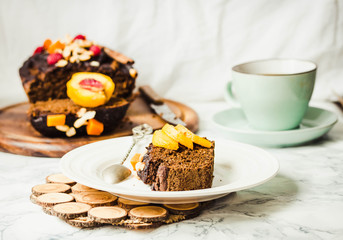 piece of chocolate cake with pumpkin, nuts and fresh peaches on