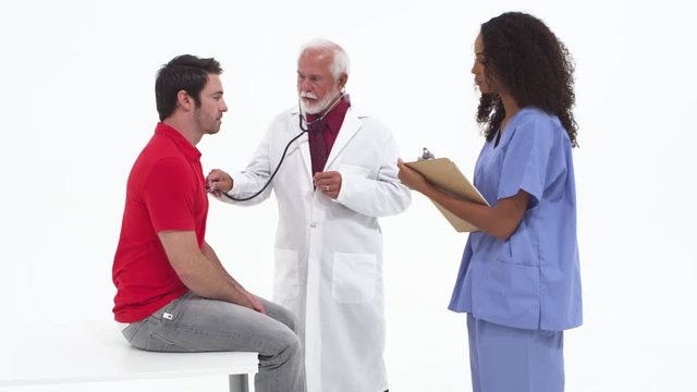 Senior doctor with nurse checking patient's health
