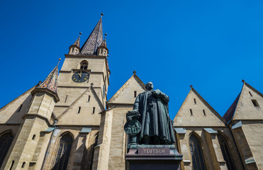 Fototapeta na wymiar Georg Daniel Teutsch monument in front of Saint Mary Lutheran Cathedral in Sibiu city in Romania