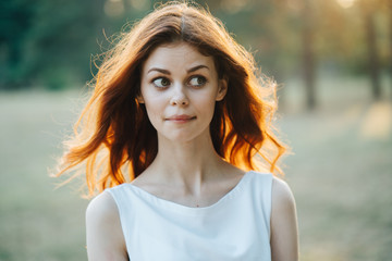 
woman in a white dress park

