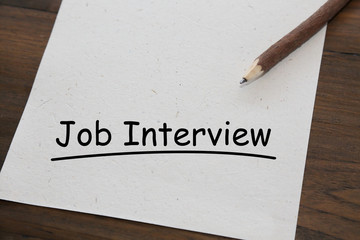 pencil with word job interview on old wood table