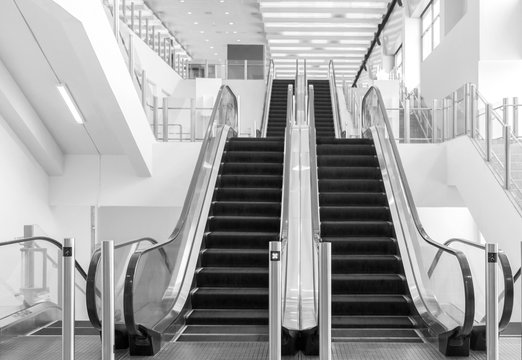 Escalator / View of empty escalator in shopping mall. Black and white tone.
