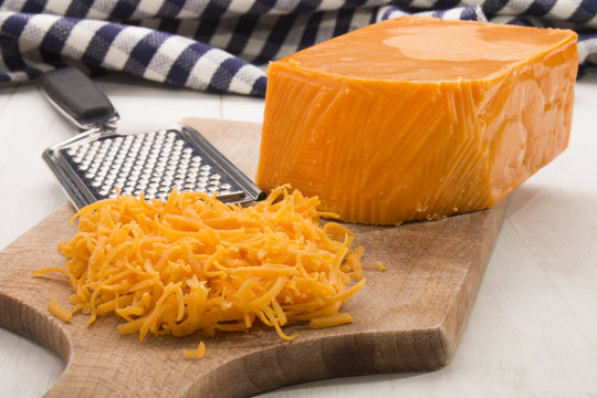 irish mature grated cheddar cheese on a wooden board