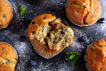 Homemade Blueberry Muffins with powdered sugar, fresh berries.