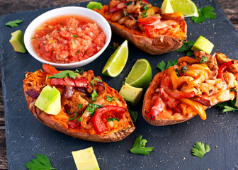 hot baked sweet potato stuffed with yellow, red pepper, chicken, cheese, herbs and salsa. selected focus