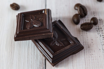 Pieces of chocolate and a coffee beans