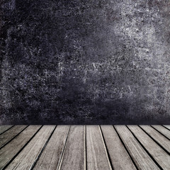 Old wooden table in front of black chalkboard vintage wall. Blac