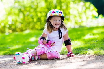 Little girl with roller skate shoes in a park