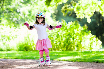 Little girl with roller skate shoes in a park