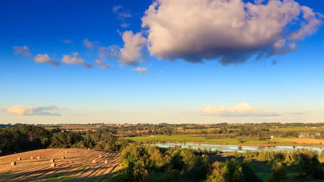Lake and field in the late afternoon. 4k timelapse. Masuria, Poland